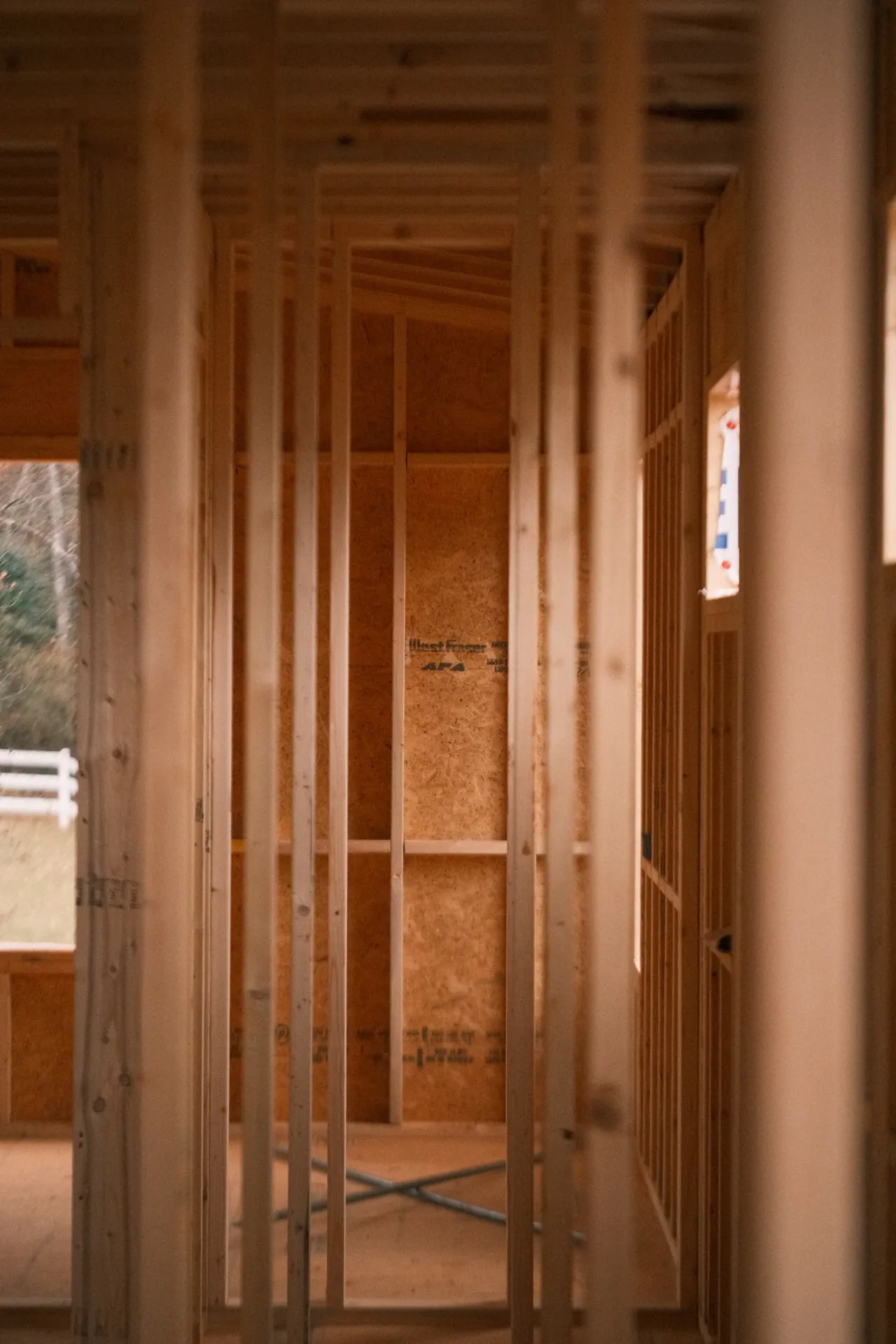 A room under construction, stripped back to timber studs and open ceiling joists